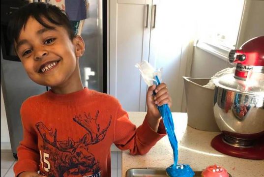 Vanilla cupcakes with cream-cheese frosting baked to perfection by a 5-year-old